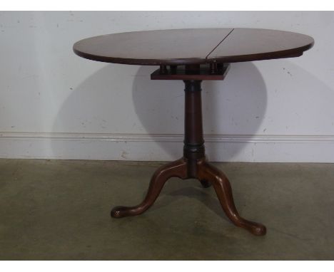 A Georgian style mahogany tripod table with a birdcage action on a turned pedestal with three outswept legs 