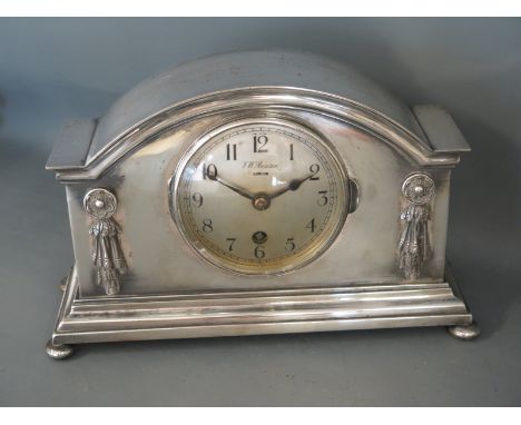 An early 20th century silver plated mantel clock of architectural form with English movement,  flowers and swag decoration, f