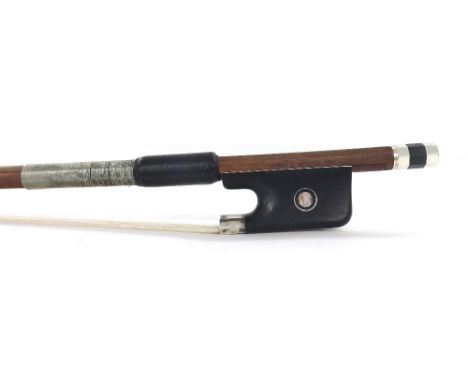 Silver mounted violoncello bow stamped Vtor Fetique a Paris, the stick round, the ebony frog inlaid with silver rings enclosi