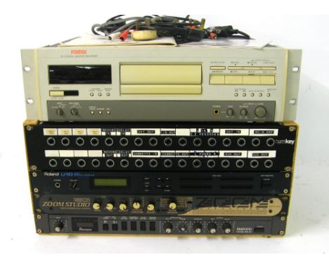Fostex D-5 digital master recorder; together with a Turn Key patch bay unit, a Roland U-110 PCM sound module rack unit, a zoo