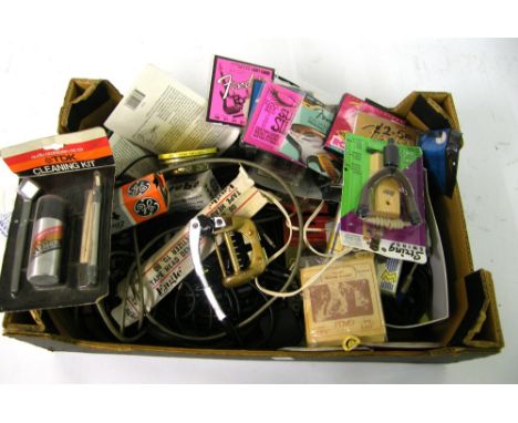 Box containing a quantity of guitar spares to include strings, amplifier valves, wall hangers, vintage vibrato tailpiece etc