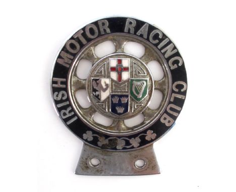 An Irish Motor Racing Club car badge A 1920s nickel plated and enamel car badge in the form of a car wheel the central disc w