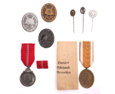 1939-1945 German Third Reich 1939 Pattern Gold, Silver and Black Wound Badges and Russian Front and West Wall Medals.  (8) To