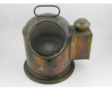A brass binnicle, of domed cylindrical form incorporating a lamp and gimbaled dry-card compass within, H. 24cm.