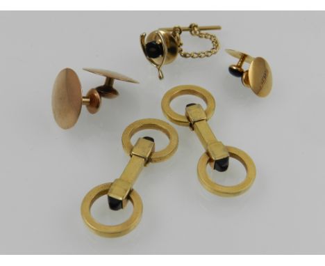 A pair of yellow metal cufflinks, together with two 18 carat yellow gold and onyx studs, a pair of 9 carat yellow gold studs,