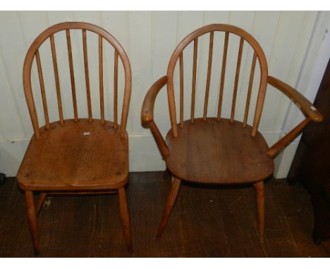 A set of four Ercol six-stick back dining chairs, to include two carvers.