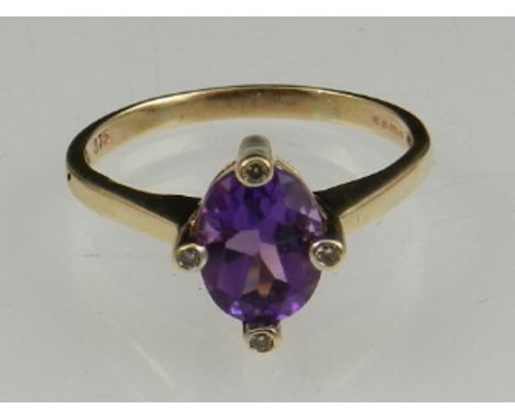 An amethyst and diamond dress ring, the oval stone set with diamonds and the cardinal points, on a yellow metal band stamped 