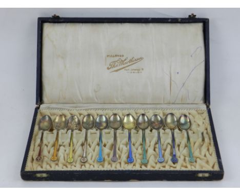A set of eleven Scandinavian silver gilt and enamel decorated spoons, boxed. 