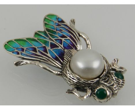 A silver, pearl, and enamel brooch in the form of an insect.