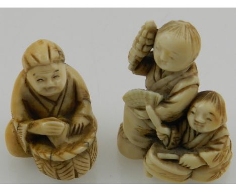 Two late 19th century Japanese ivory netsuke, one of a couple playing musical instruments, the other of a sitting figure with