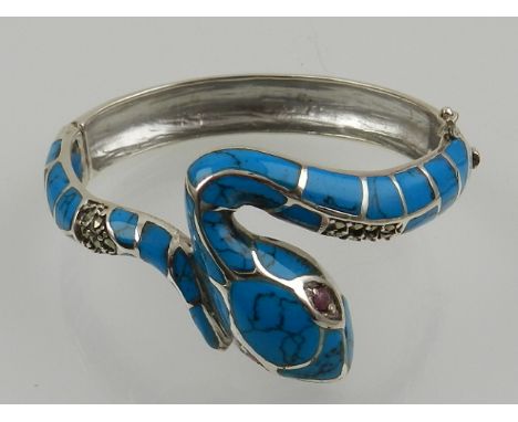 A white metal and turquoise set bangle bracelet, in the form of a snake.