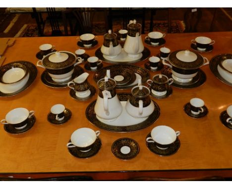 A Wedgwood part dinner/coffee service, with Caernarvon pattern, to include tureens, coffee and tea pots, platters, etc.