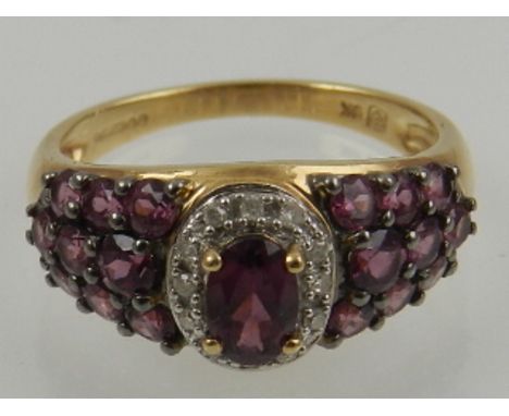 A 9 carat yellow gold, amethyst, and pink topaz cluster ring. 