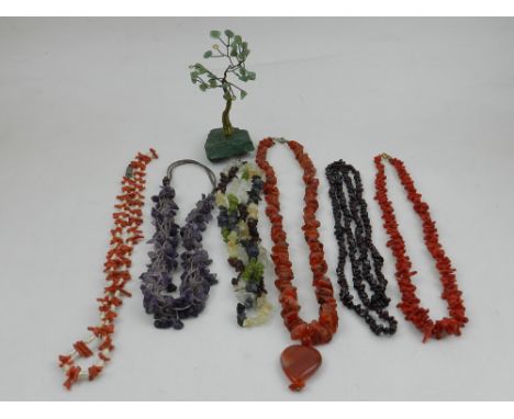 A collection of seven various beaded necklaces, to include garnet, amethyst, and coral examples. (7)