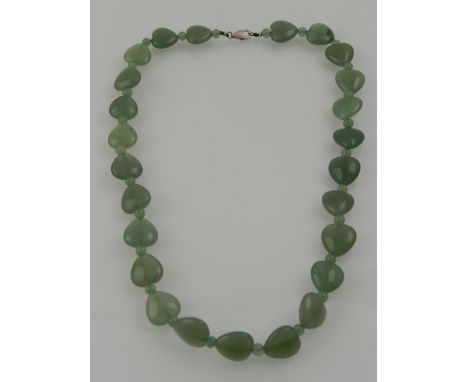 A jade necklace, caved in the form of hearts inter-spaced with smaller beads.