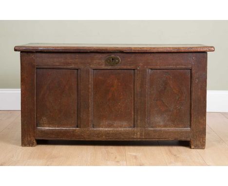 An oak coffer with iron lock plate, on low feet, stamped to the side 'R. P.', with triple panelled front, 109cm wide, 43cm de