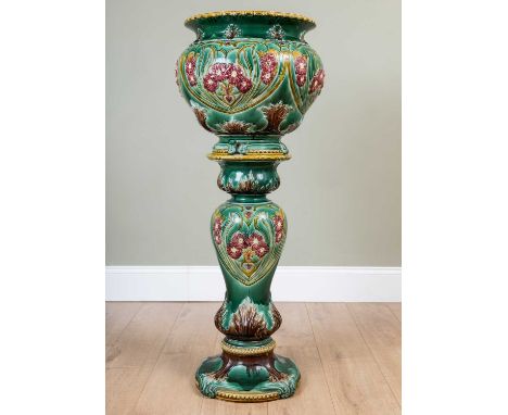 A Victorian maiolica jardiniere or Aspidistra stand with green ground pottery decorated in light relief with flowers, 45cm di