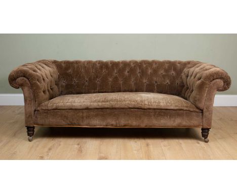 A Chesterfield sofa with button upholstered back and turned front legs, all on later casters, 214cm wide x 96cm deep x 70cm h