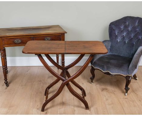 A Victorian low armchair with shaped button upholstered back and carved cabriole legs together with a folding coaching table 