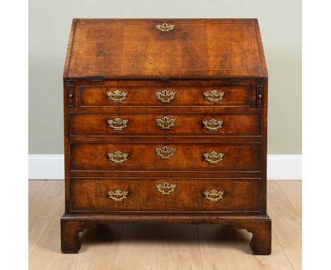 An 18th century walnut bureau the fall front enclosing a fitted interior over four long drawers, standing on bracket feet, 94