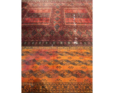 An Oriental orange ground rug with multiple banded border, 336cm x 232cm; together with a modern machine made rug, 350cm x 25