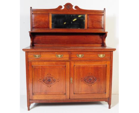 An Edwardian circa. 1900's walnut Arts &amp; Crafts sideboard credenza. The sideboard having a mirror to centre flanked by tw