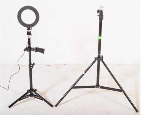 A contemporary small studio LED light set lamps. Having an extendable ebonised tubular tripod stand with a circular LED light