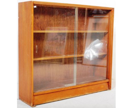 British Modern Design - Mid century teak wood sliding glass door library bookcase. Raised on an inset plinth base with twin g