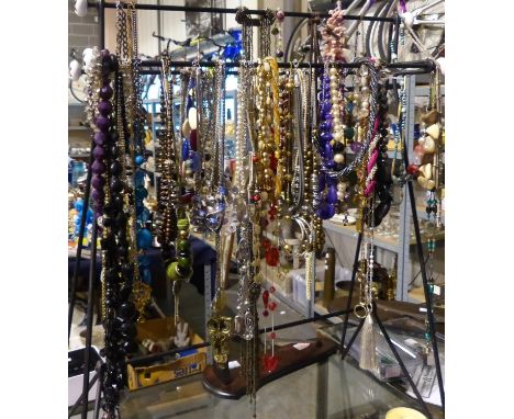 Mixed costume jewellery necklaces, mainly bead examples, on a display stand. Not available for in-house P&amp;P 