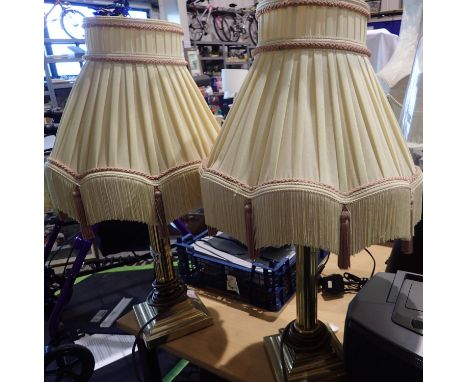 Pair of brass columnar lamps, with fringed shades, H: 60 cm including shade. All electrical items in this lot have been PAT t
