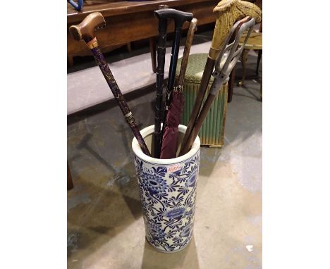 Blue and white ceramic stick stand with umbrella and walking sticks. Not available for in-house P&amp;P 