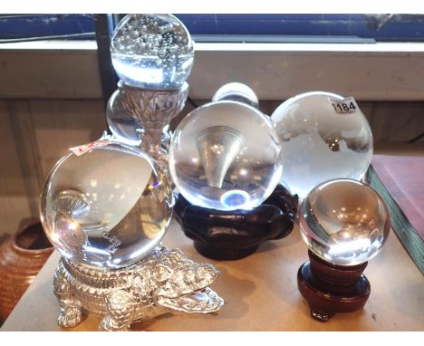 Quantity of glass balls, each raised on a decorative stand, largest H: 28 cm. Not available for in-house P&amp;P 