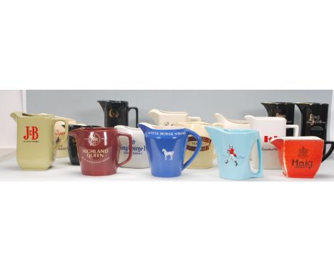 A collection of vintage advertising ceramic whiskey jugs to include Bell's, Chivas, Ballantines, Long John etc.&nbsp;