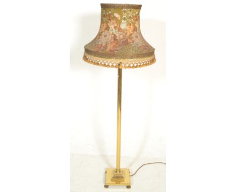 A good quality antique style 20th century brass standard lamp. Raised on a plinth square base with hairy paw feet. Above, a t