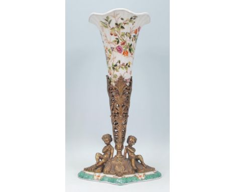 A 20th Century William Lowe centerpiece vase, the vase of tapering form with a fanned rim with floral decoration supported by