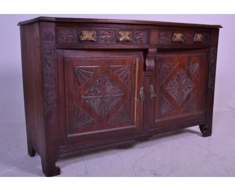 An Edwardian walnut Art Nouveau dresser base. Raised on stile legs with double doors over cupboards beneath having shelves wi