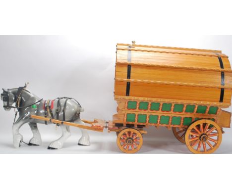 A large vintage 20th Century Gypsy Caravan and shire horse. The gypsy wagon of domed form with hand painted red and green dec