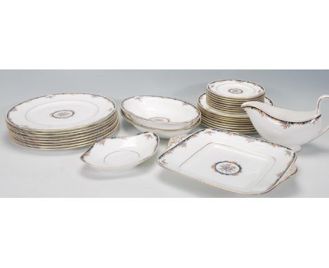 A Wedgwood Bone China dinner service in the Osborne R 4699 pattern, consisting of eight dinner plates, eight side plates, eig