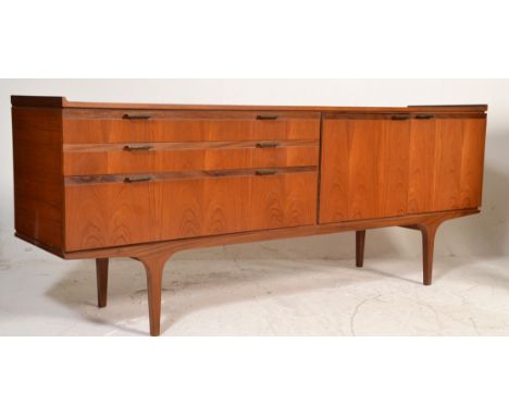 A mid century Danish inspire teak wood sideboard credenza being raised on tapering legs with&nbsp; a double door cupboard fla