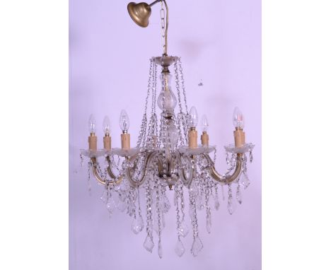 A good 20th century 8 arms cristal chandelier having faceted drops, gilded power cable and candle style light bulbs. Measures