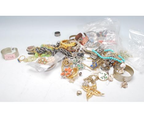 A collection of vintage costume jewellery to include necklaces, bracelets, brooches, rings, faux pearls, a white metal bark e