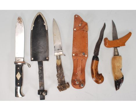 A collection of 20th century hunting knives to include SAS example within scabbard, Palestinian knife and others, one with ho