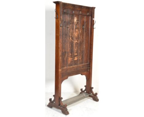 A 19th century mahogany church vestry clothes rack - coat stand / hall stand having tall upright panel body with hools atop b