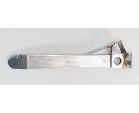A good silver hallmarked cigar cutter of lung rectangular form having engine turned decoration and rounded end. Hallmarked fo