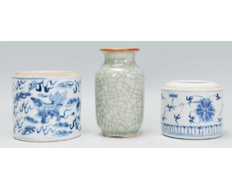 A group of three Chinese ceramic ornaments to include a blue and white pot of cylindrical form being hand painted with mythic