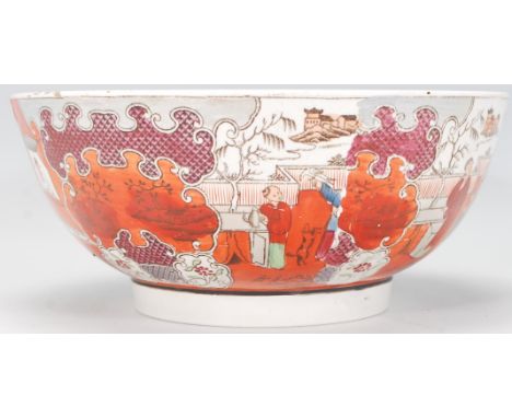 A 19th Century English ceramic centrepiece fruit bowl having transfer printed rim decoration in the Chinese taste with hand d