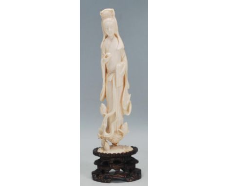 A 19th Century Chinese carved ivory statue / figurine in the form of Guanyin, the Buddhist goddess of compassion, being raise