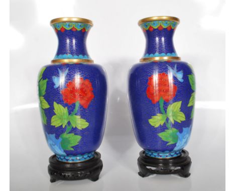 A 20th Century pair of Chinese cloisonne enamel vases with a baluster form. Decorated with a pattern of birds and peonies. Co