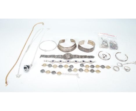 A selection of mixed silver and silver white metal jewellery to include a silver bangle with pierced banded decoration, a sil