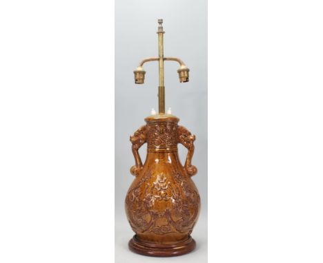 A vintage 20th Century Chinese converted lamp finished in a brown glaze having&nbsp;two dragons chasing a flaming pearl and c